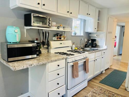 a kitchen with white cabinets and a stove top oven at Dafna, Unit 4 in Cromberg
