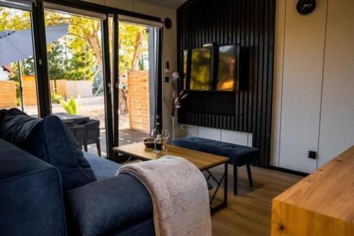 a living room with a blue couch and a table at Lutek in Olsztynek