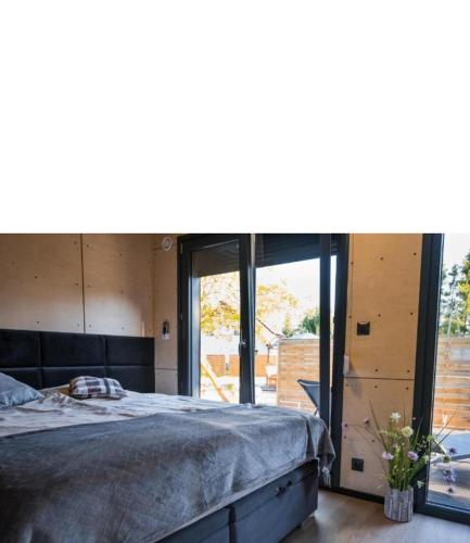 a bedroom with a large bed and a large window at Lutek in Olsztynek