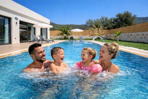 a group of people in a swimming pool at villa tera Private Pool & jacuzzi in Fethiye