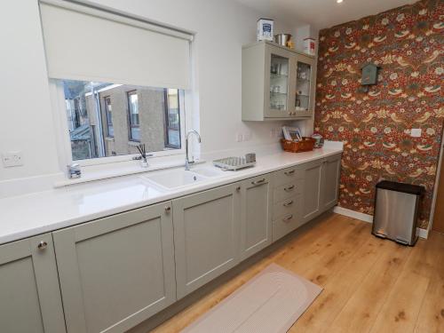 a kitchen with a sink and a window at Amber Rose in Berwick-Upon-Tweed