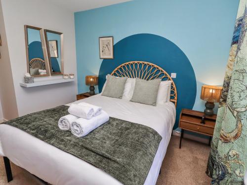 a bedroom with a large bed with towels on it at Amber Rose in Berwick-Upon-Tweed