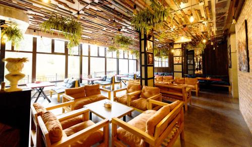 a large room with couches and tables and windows at LOFT Hotel & SPA in Bukovel