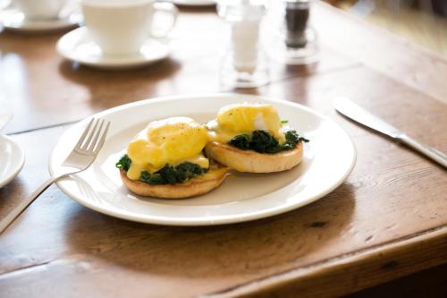 a plate of food with eggs on a table at Brooks Guesthouse Bristol in Bristol