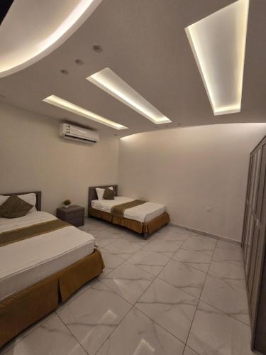 two beds in a large room with two bedsvisor at شالية سحاب in Rayyis
