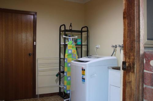 a small refrigerator in a room with a shelf at Willunga Farm Retreat in Willunga