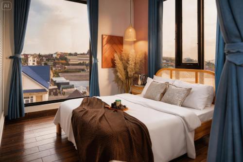a bedroom with a large bed and a large window at Beyoung Hotel Dalat in Da Lat