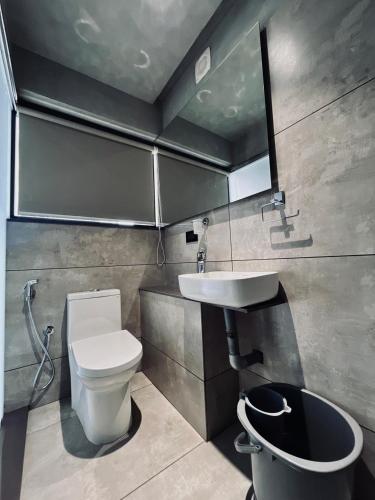 a bathroom with a toilet and a sink at BEL VISTO in Vālpārai