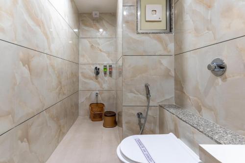 a bathroom with a shower with a toilet in it at Hotel Altura CHHATRAL in Nandāsan