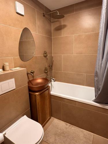 a bathroom with a toilet and a bath tub at S1 Vilnius in Vilnius