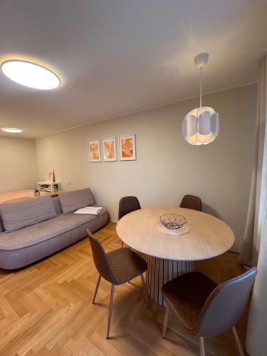 a living room with a table and a couch at S1 Vilnius in Vilnius