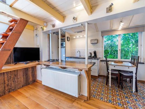 a kitchen with a sink and a table in a room at Snug Holiday Home in Nieuwvliet in Nieuwvliet
