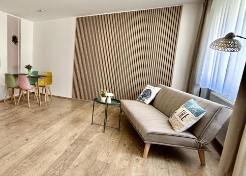 a living room with a couch and a table at NEU Apartmenthaus-Usedom Familie Stopp Kajüte 7 - Balkon - strandnah in Kölpinsee