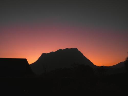 a silhouette of a mountain at sunset at The CAMPIAN in Chiang Dao