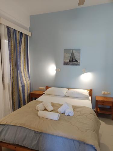 a bedroom with a bed with towels on it at Maria's Apartments in Kalyves