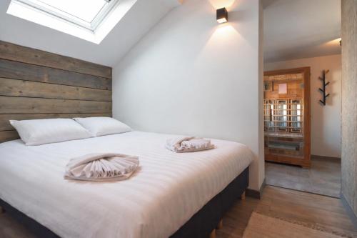 a bedroom with a bed with two pillows on it at Joy at the Beach in Zandvoort