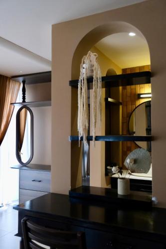 a kitchen with a black table and a mirror at HIDE&SEEK Homestay in Ấp Tân An (1)