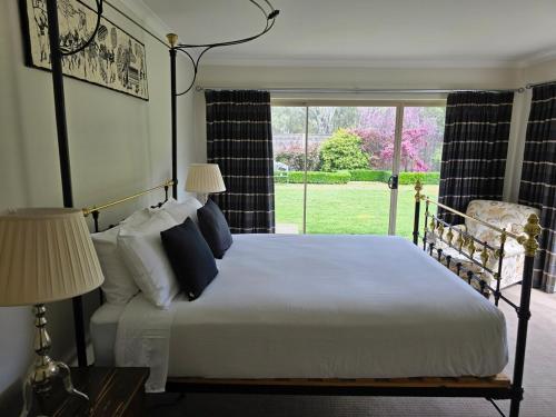 a bedroom with a large white bed with a window at River view in Shepparton