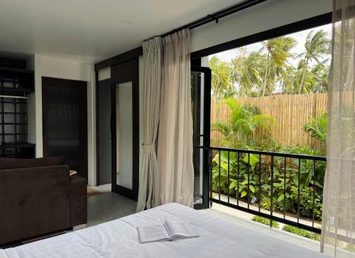 a bedroom with a bed and a large window at Aranya Bliss Villa 103 in Wok Tum