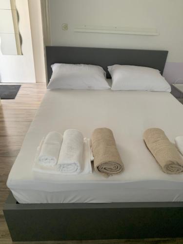 a white bed with towels and pillows on it at Klancic 10 in Novi Vinodolski