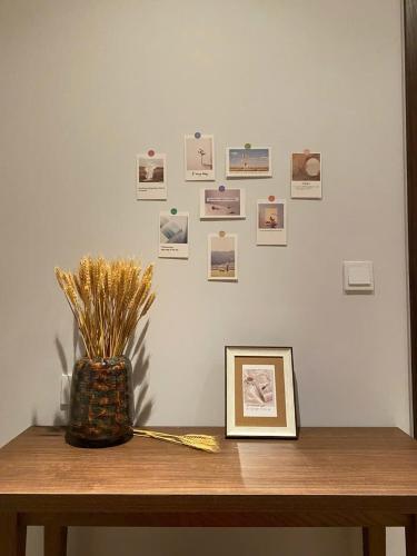 a table with a picture on a wall with photos at The Seafront Condotel - Apec Mandala in Mui Ne