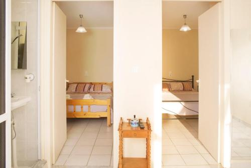 a room with two beds and a bathroom at CouCouNaries in Nisís Ánidhro