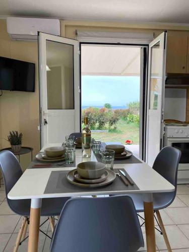 a table with plates and glasses on it in a kitchen at CouCouNaries in Nisís Ánidhro