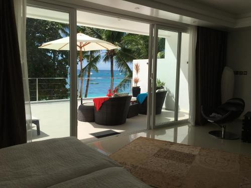 a bedroom with a bed and a view of the ocean at Sundown Beach Studios in Boracay