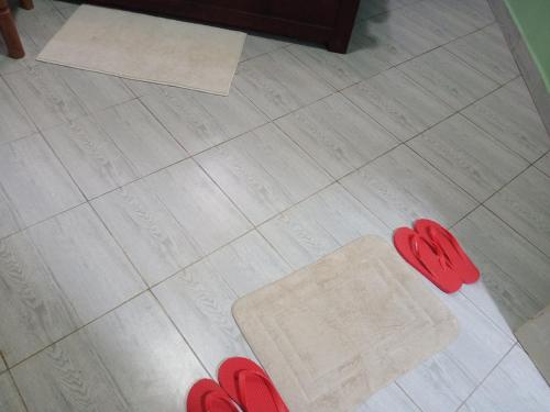 a pair of red shoes on a tile floor at BRACCK Suites in Nakwero