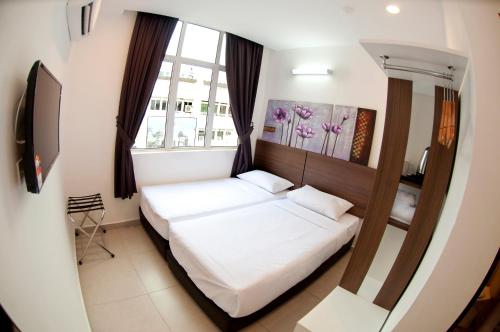 Una cama o camas en una habitación de Hotel Cheqinn