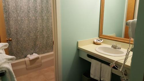 a bathroom with a sink and a mirror at Cascades Lodge in Killington