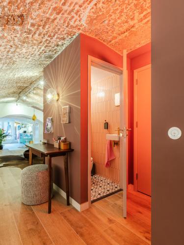 an office with an orange wall and a desk in a room at Wilsons in Utrecht