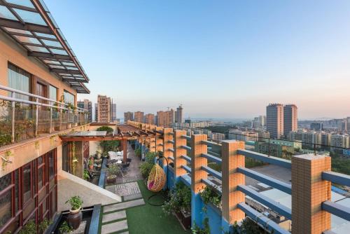 an apartment building with a view of a city at Mercure Xiamen Exhibition Centre in Xiamen