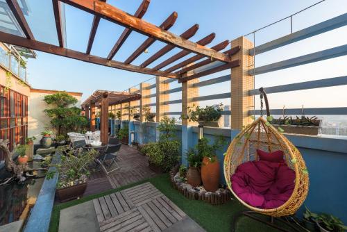 a patio with a hammock on a balcony at Mercure Xiamen Exhibition Centre in Xiamen