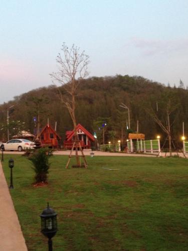 a park with a playground with a swing at บ้านเรือนไท มวกเหล็ก Ban Ruenthai MuakLek in Muak Lek District