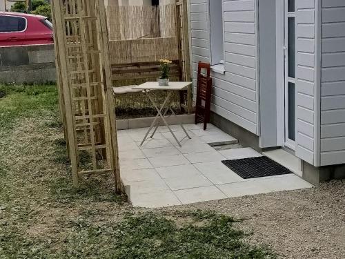 a small table on a patio next to a house at Studio85 in La Gaubretière