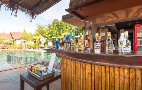 a bar at a resort with a pool at Poonsiri Resort Aonang-SHA Extra Plus in Ao Nang Beach