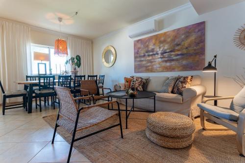 a living room with a couch and a table at Quinta do Pedro in Luz de Tavira