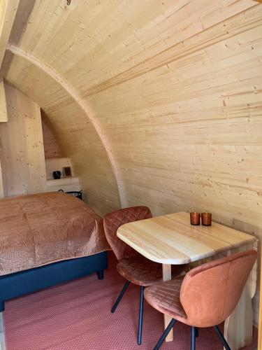 a bedroom with a bed and a table and chairs at Parc Boulée in Ven-Zelderheide