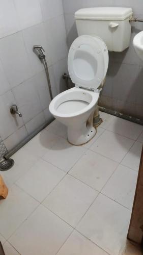 a bathroom with a white toilet in a room at Nepal VaNaVaS Retreat in Changunarayan