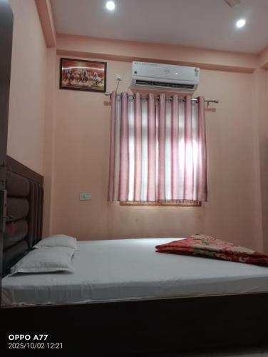 a bedroom with a bed and a window with a heater at Nepal VaNaVaS Retreat in Changunarayan