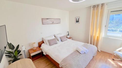 a bedroom with a white bed and a window at Luxury Beach Villa, Sibenik in Šibenik