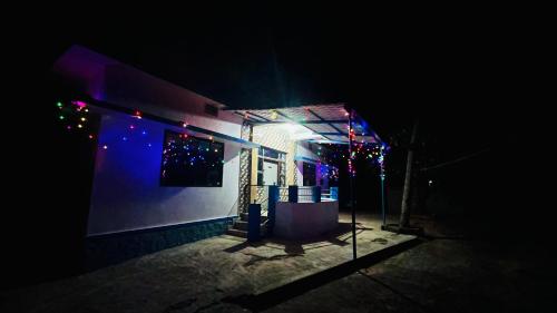 a house with christmas lights on it at night at Arabian Shore - Udupi in Malpe
