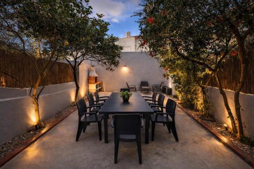 a black table and chairs on a patio with lights at Charneca Mar & Sol in Charneca