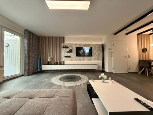 a living room with a couch and a tv on a wall at Ferienwohnung W&S in Hettstedt