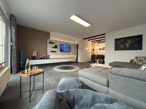 a living room with a couch and a table at Ferienwohnung W&S in Hettstedt