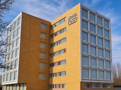 a tall brick building with a sign on it at Hotel Fogo Amsterdam in Amsterdam