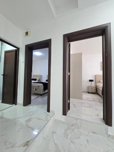 a white room with two doors and a bedroom at Villa Ivanovic in Podgorica