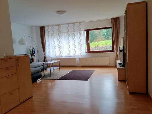 a living room with a couch and a window at Ferienwohnung Notos- Eislingen in Eislingen