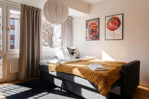 a bedroom with a bed and a window at Guestly Homes - Central Premium Suite 1BR in Västerås